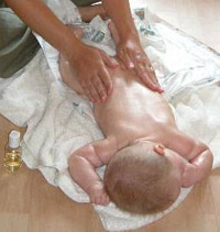 Massaging a new born baby