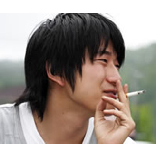 Young Man Smoking A Cigarette