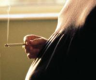 A pregnant lady smoking a cigarette